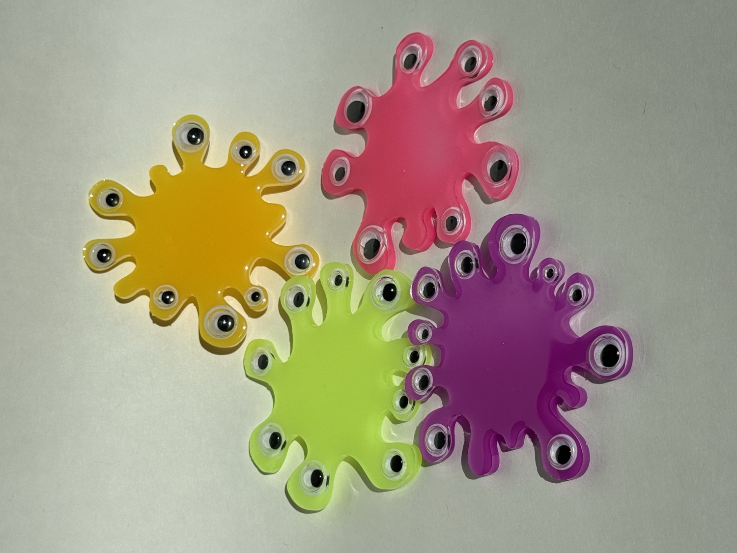 Bright neon splat coasters with googly eyes