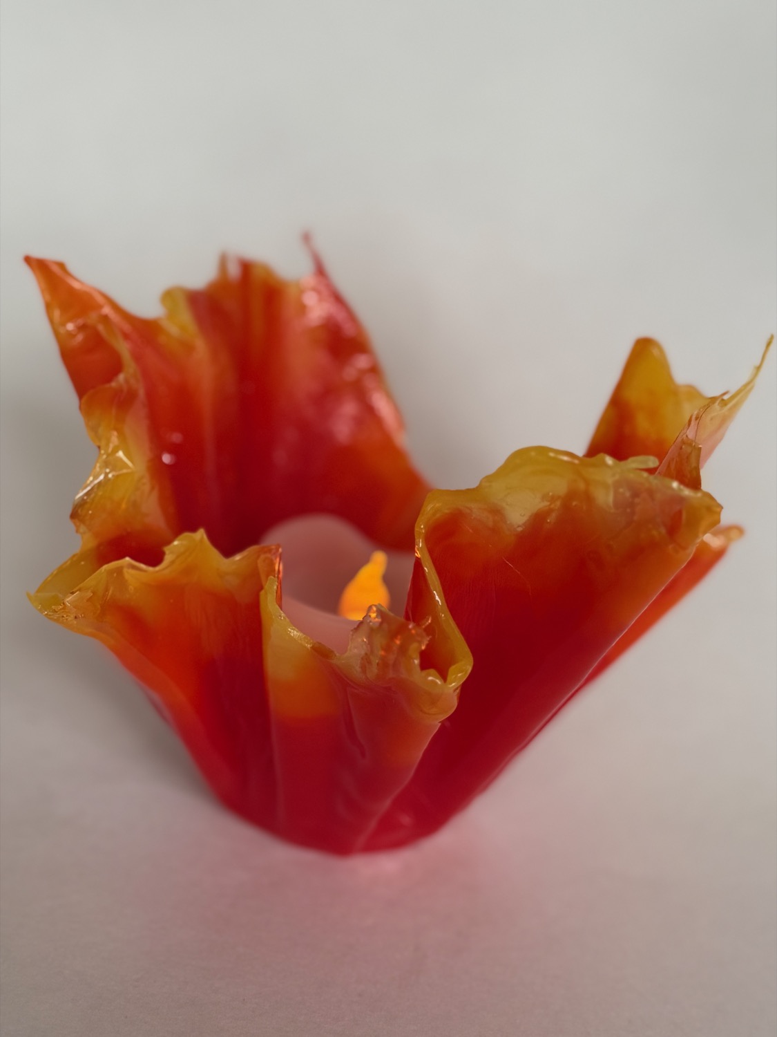 Red orange ruffled bowl with candle
