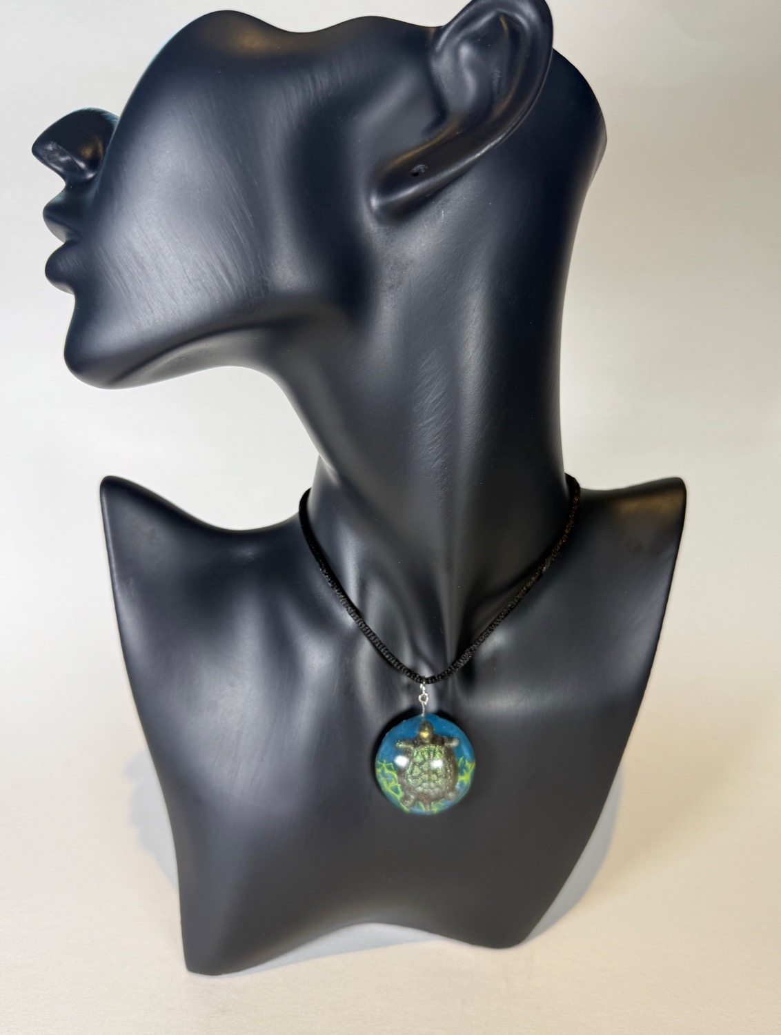 Round blue pendant with sea turtle and seaweed