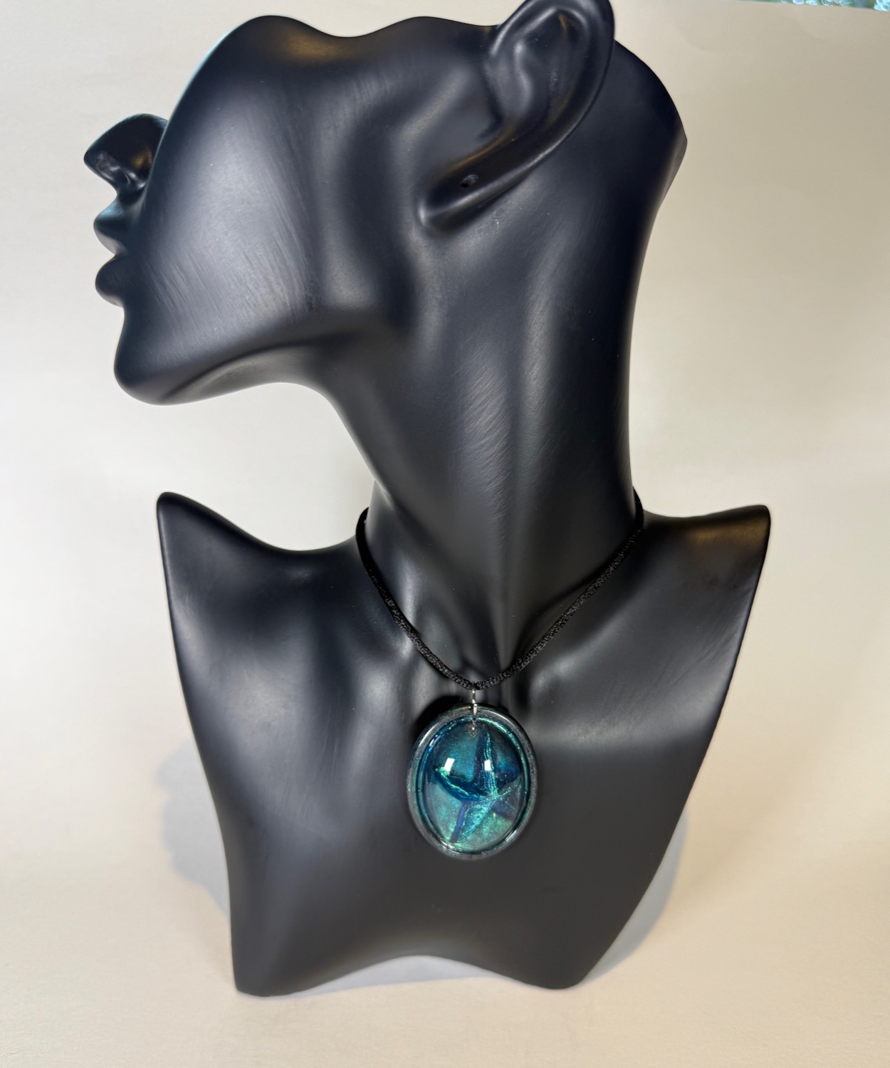 Teal oval pendant with holographic starfish
