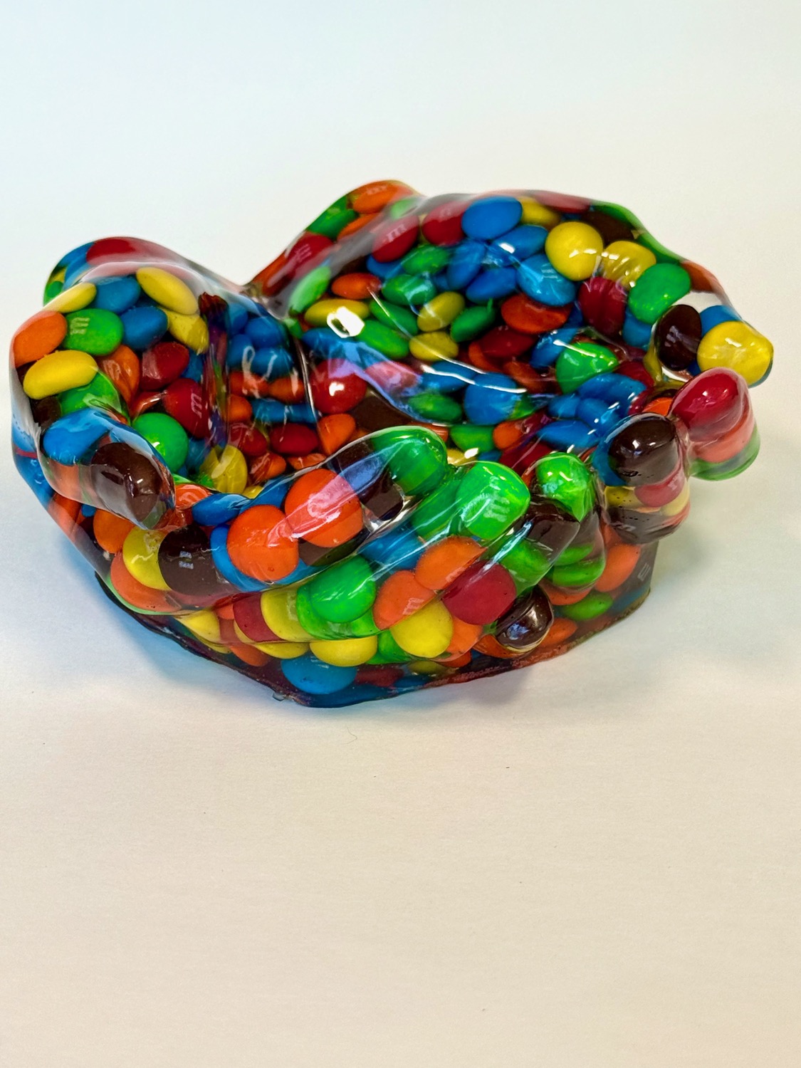 M&M Hands — resin cupped hands completely embedded with M&M candies