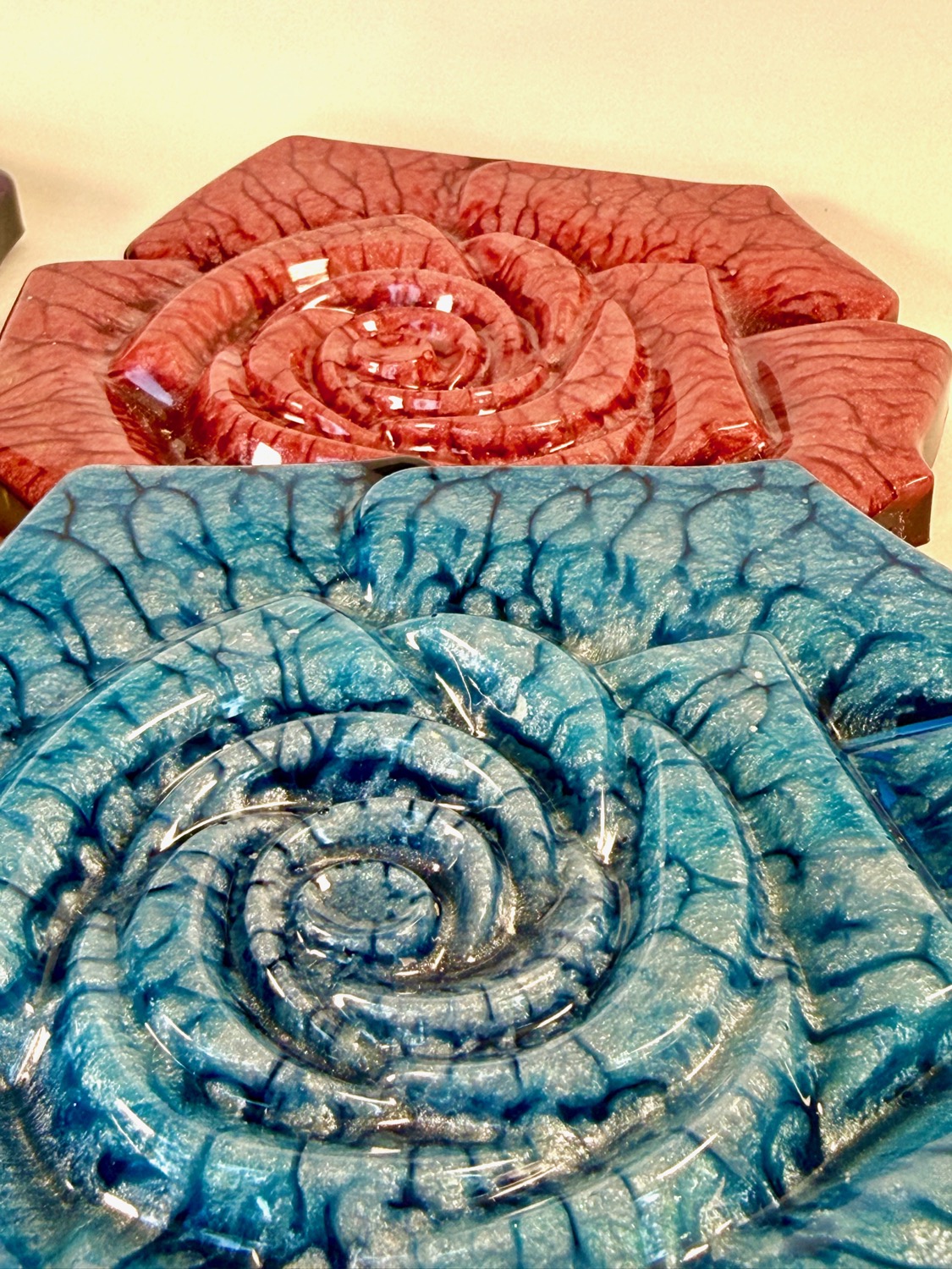 Red and blue Crackling Rose coasters close-up