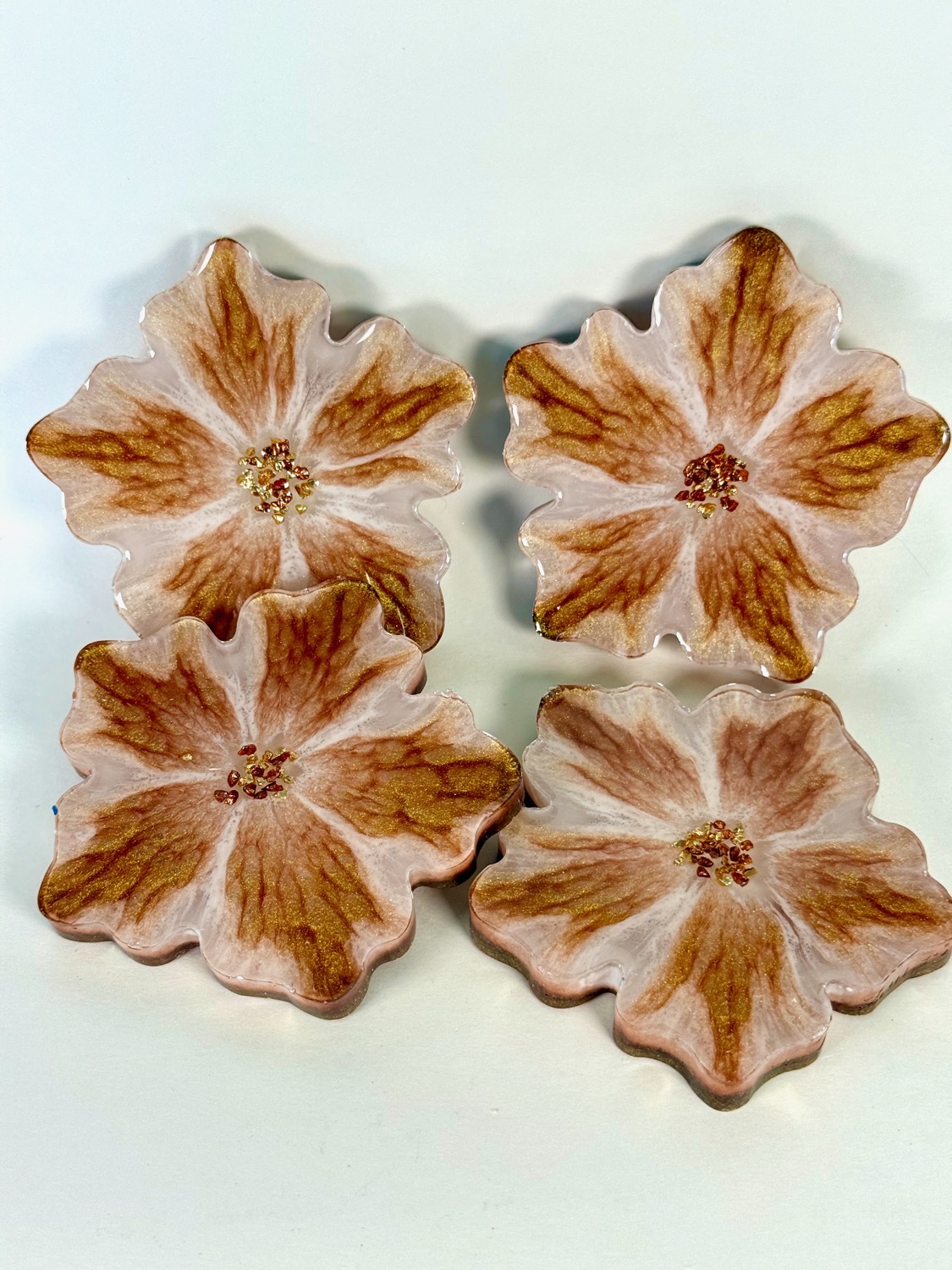 Set of 4 blush pink flower-shaped resin coasters with gold shimmer