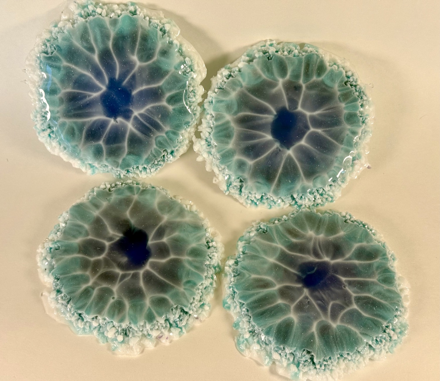 Set of 4 ice blue geode resin coasters with white crystal edges