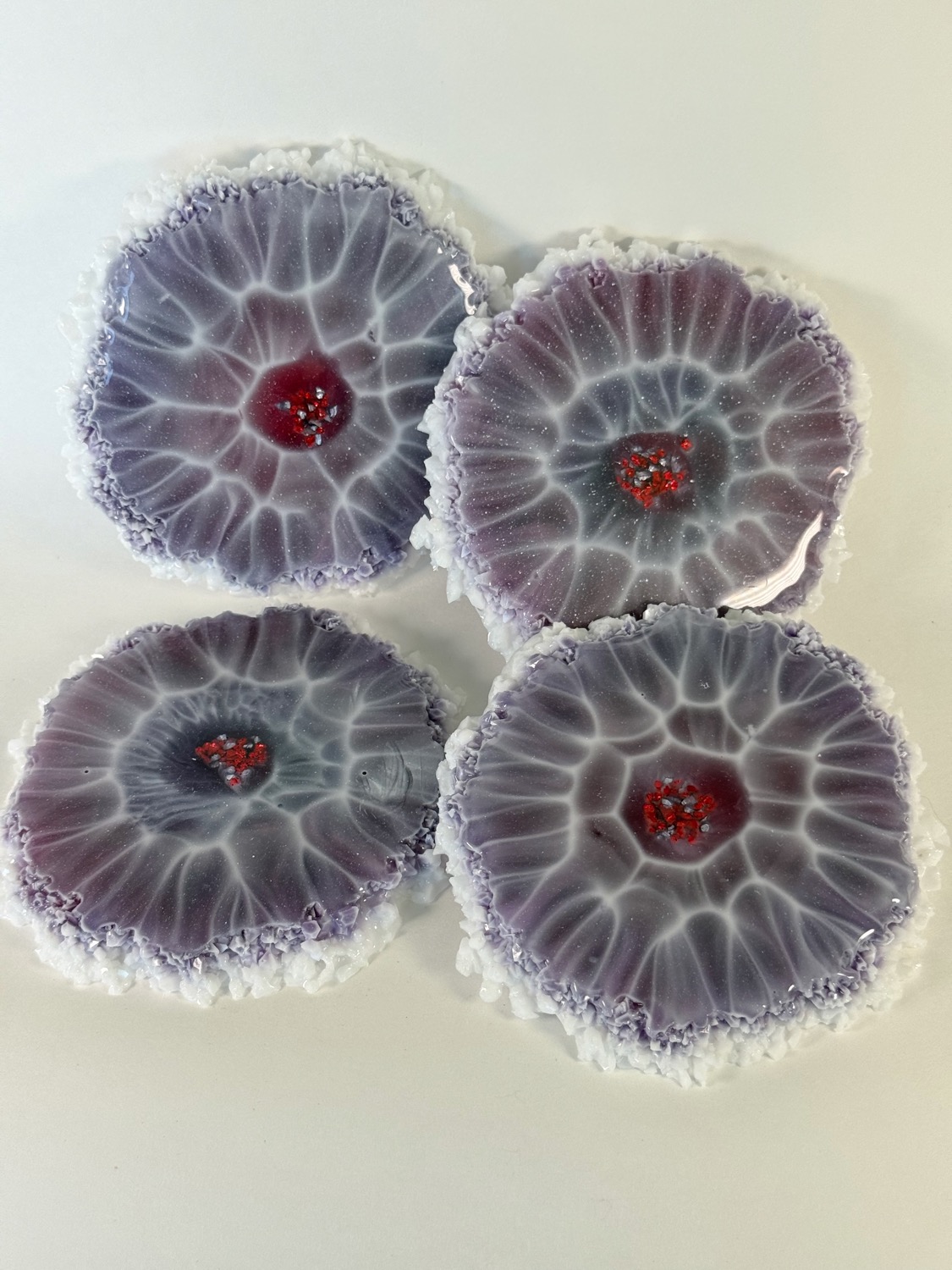 Set of 4 lavender geode resin coasters with red glitter centres