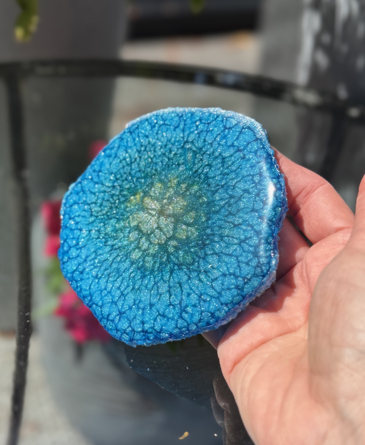 Cobalt Bloom coaster held in hand outdoors