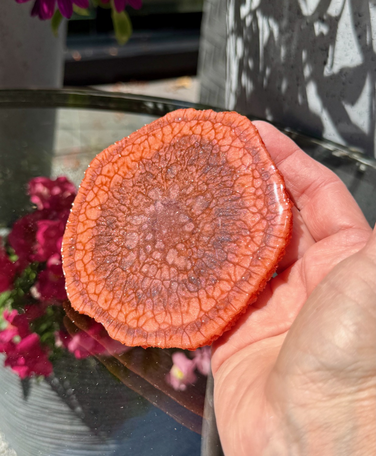 Terracotta Geode coaster held in hand outdoors