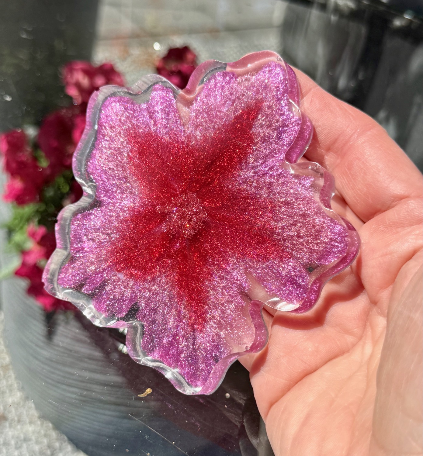 Orchid Blossom coaster held in hand outdoors