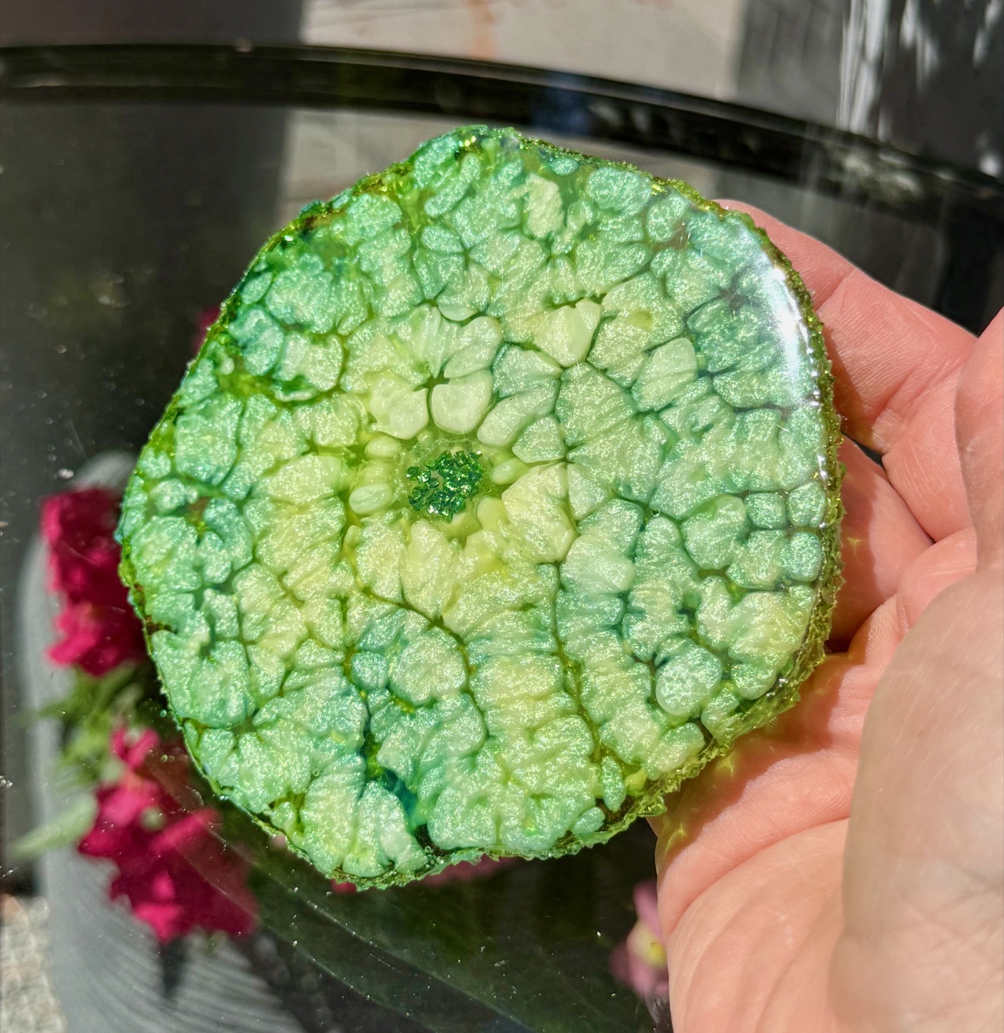 Jade Geode coaster held in hand outdoors