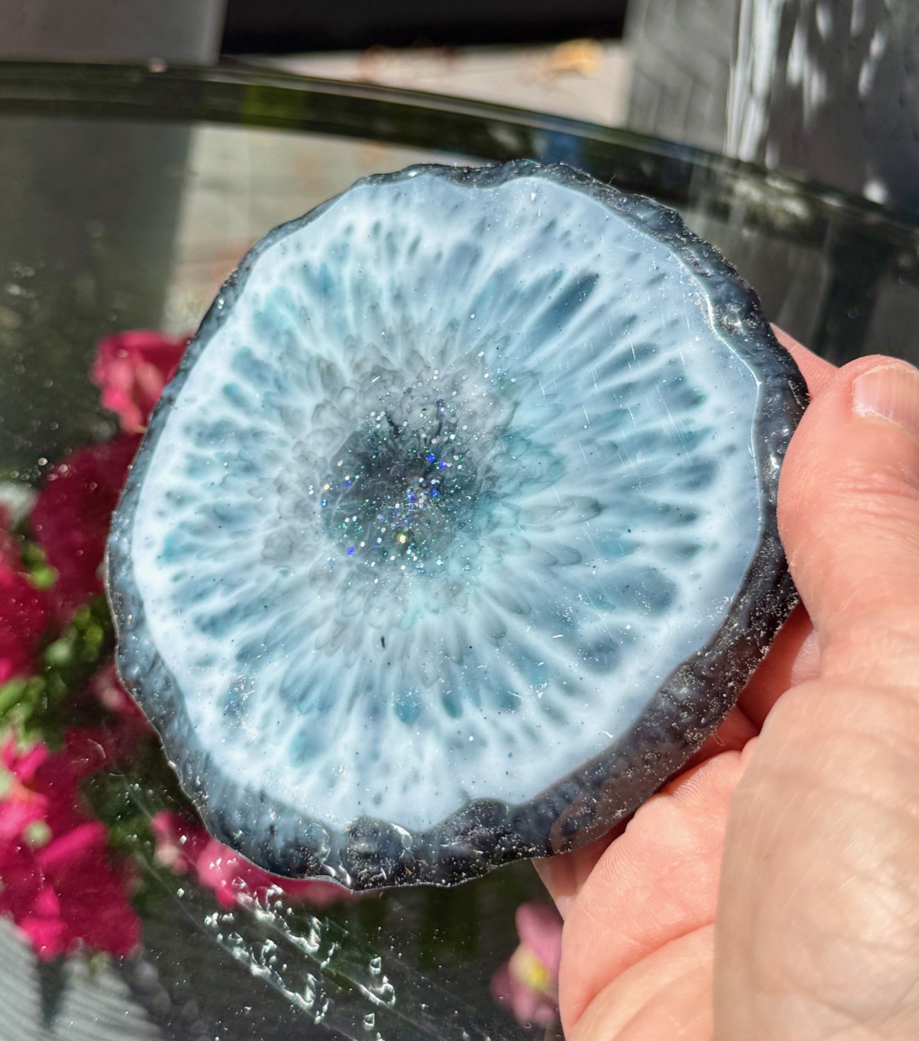 Stormcloud Geode coaster held in hand outdoors