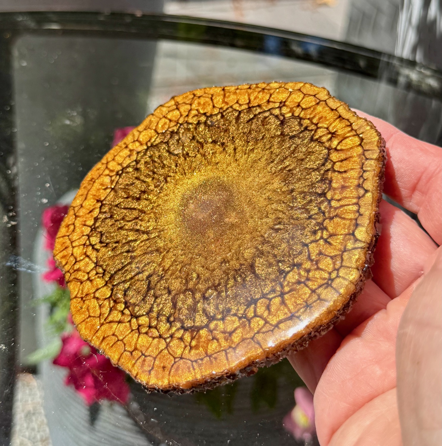 Amber Geode coaster held in hand outdoors