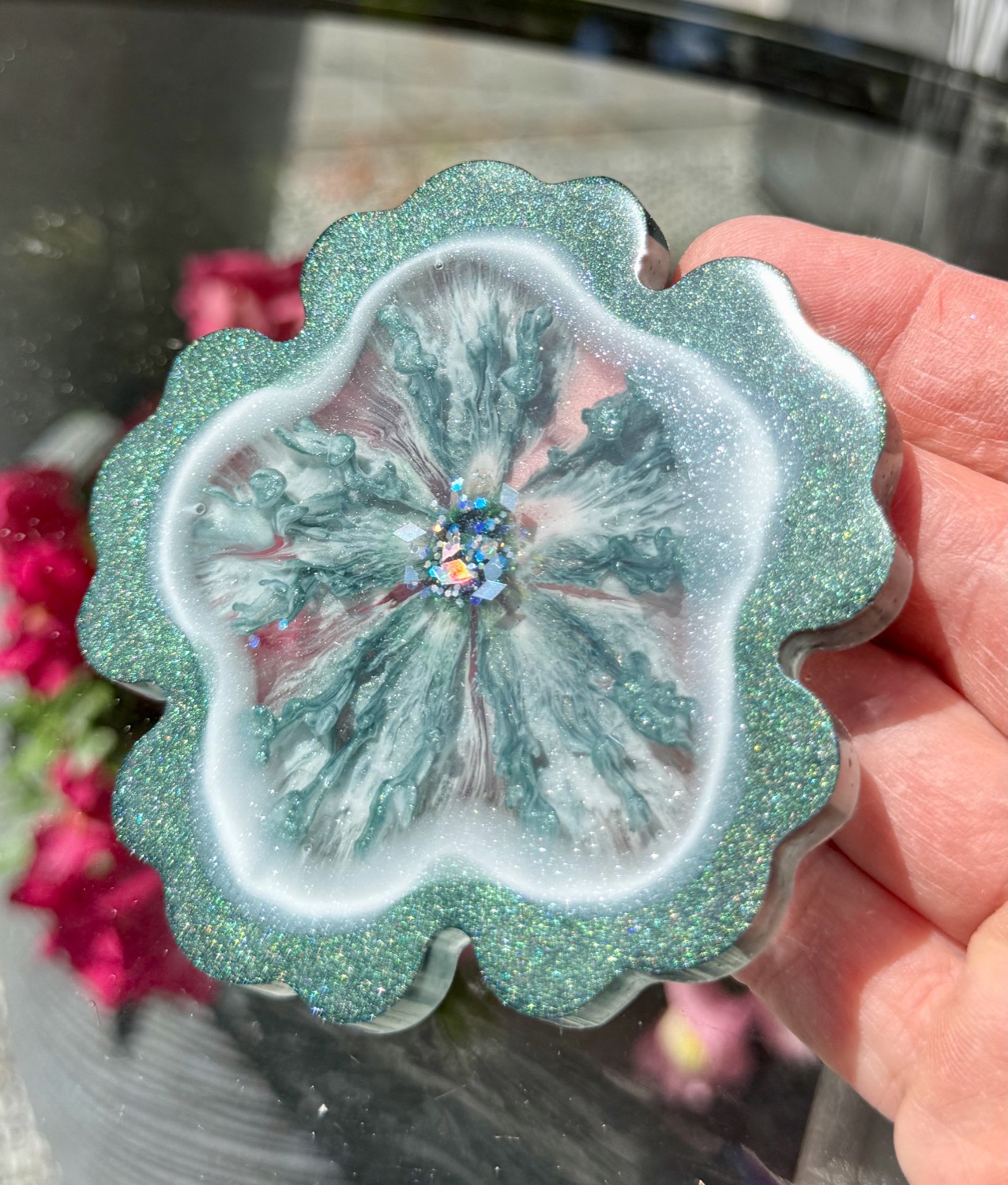 Forest Blossom coaster held in hand outdoors