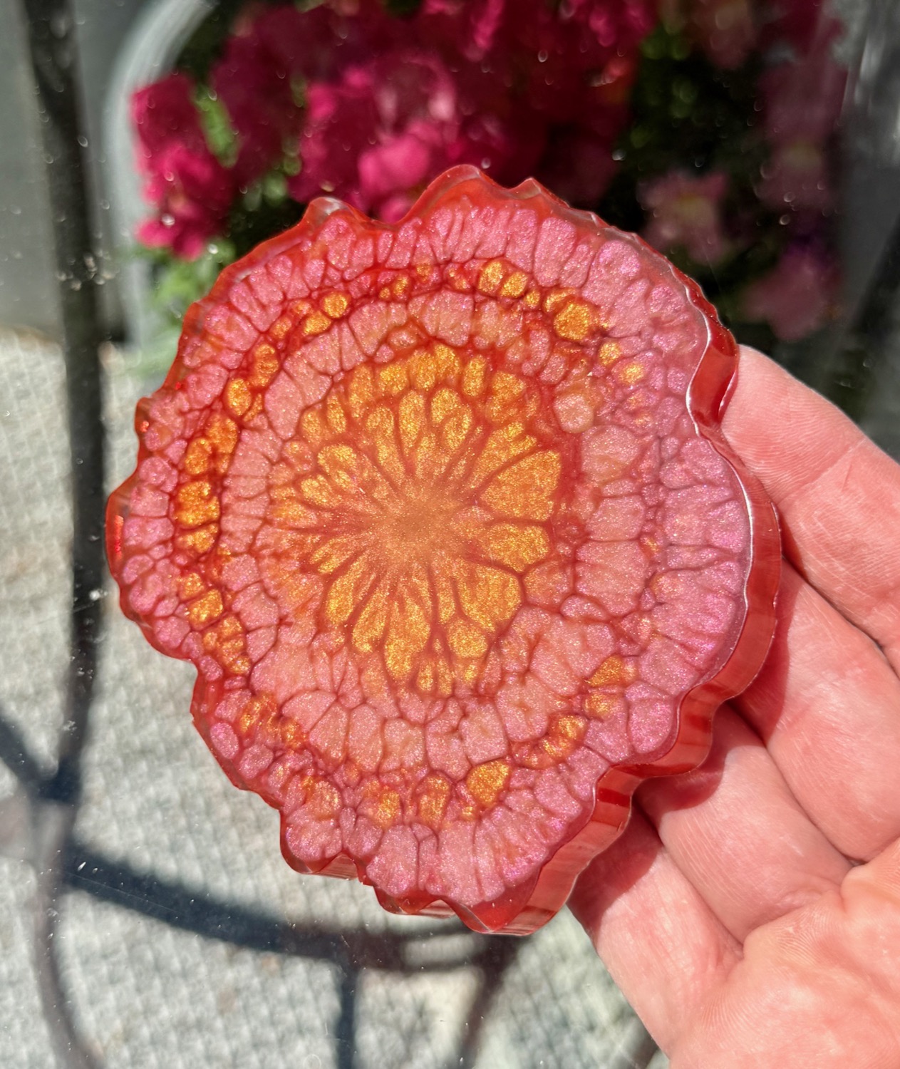 Marigold coaster held in hand outdoors