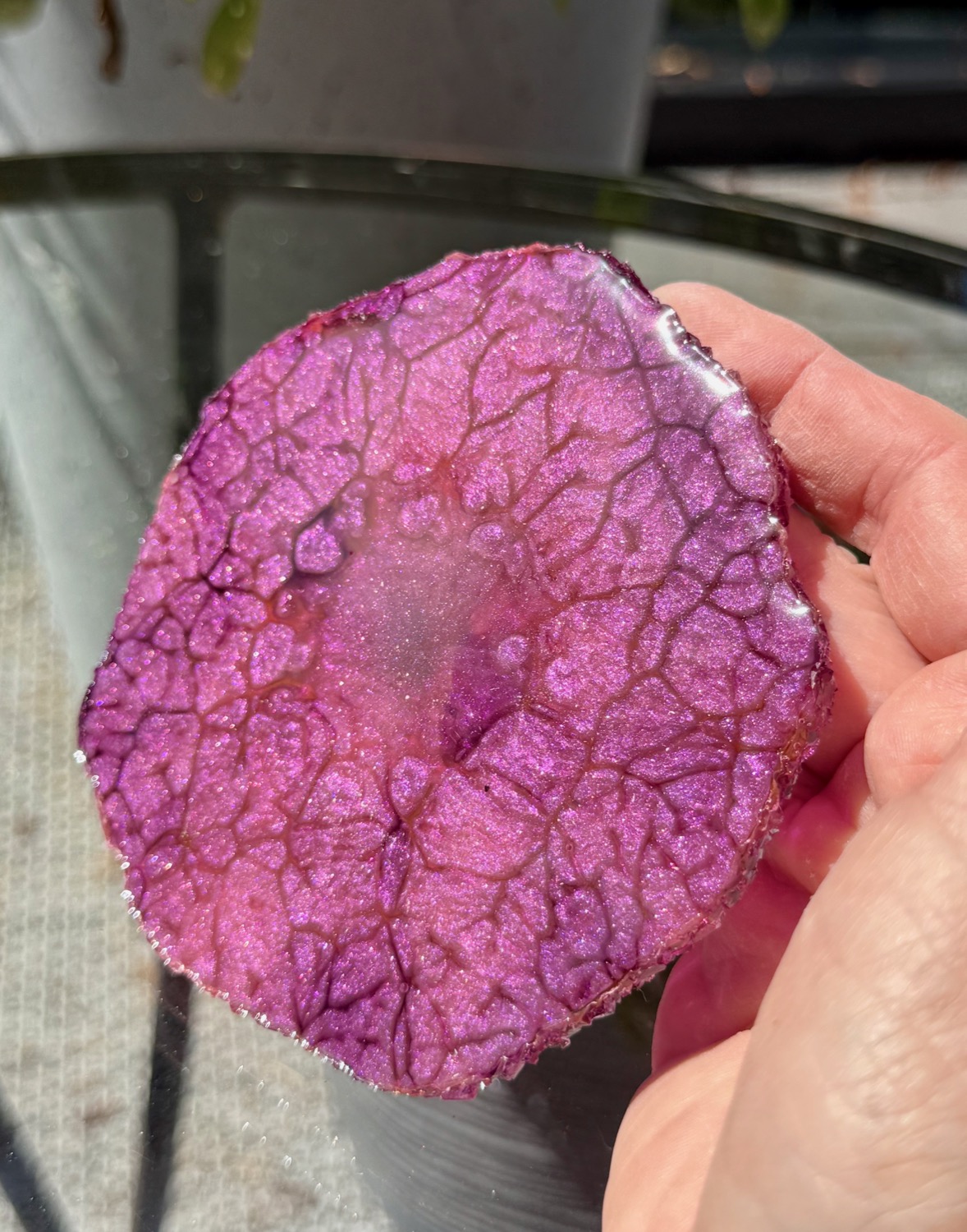 Magenta Geode coaster held in hand outdoors