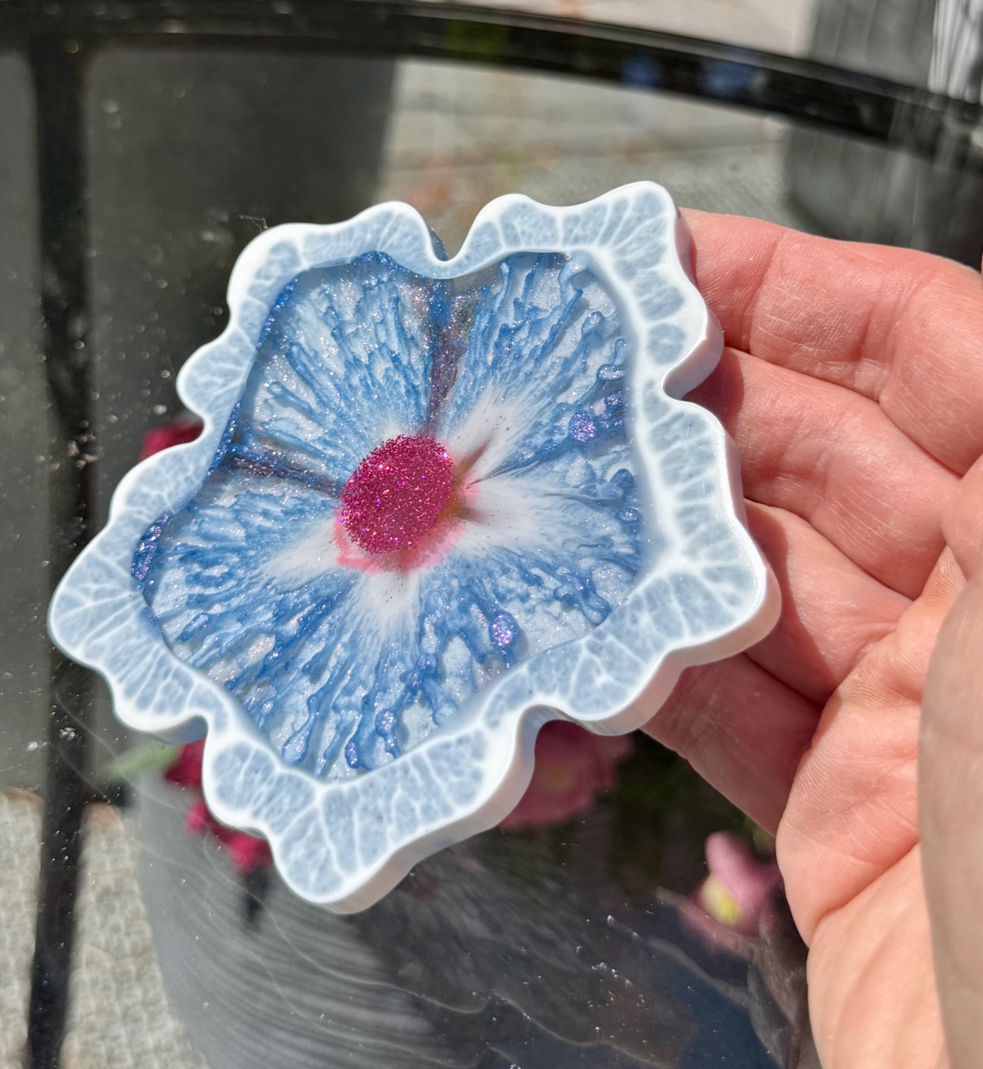 Meadow Blossom coaster held in hand outdoors