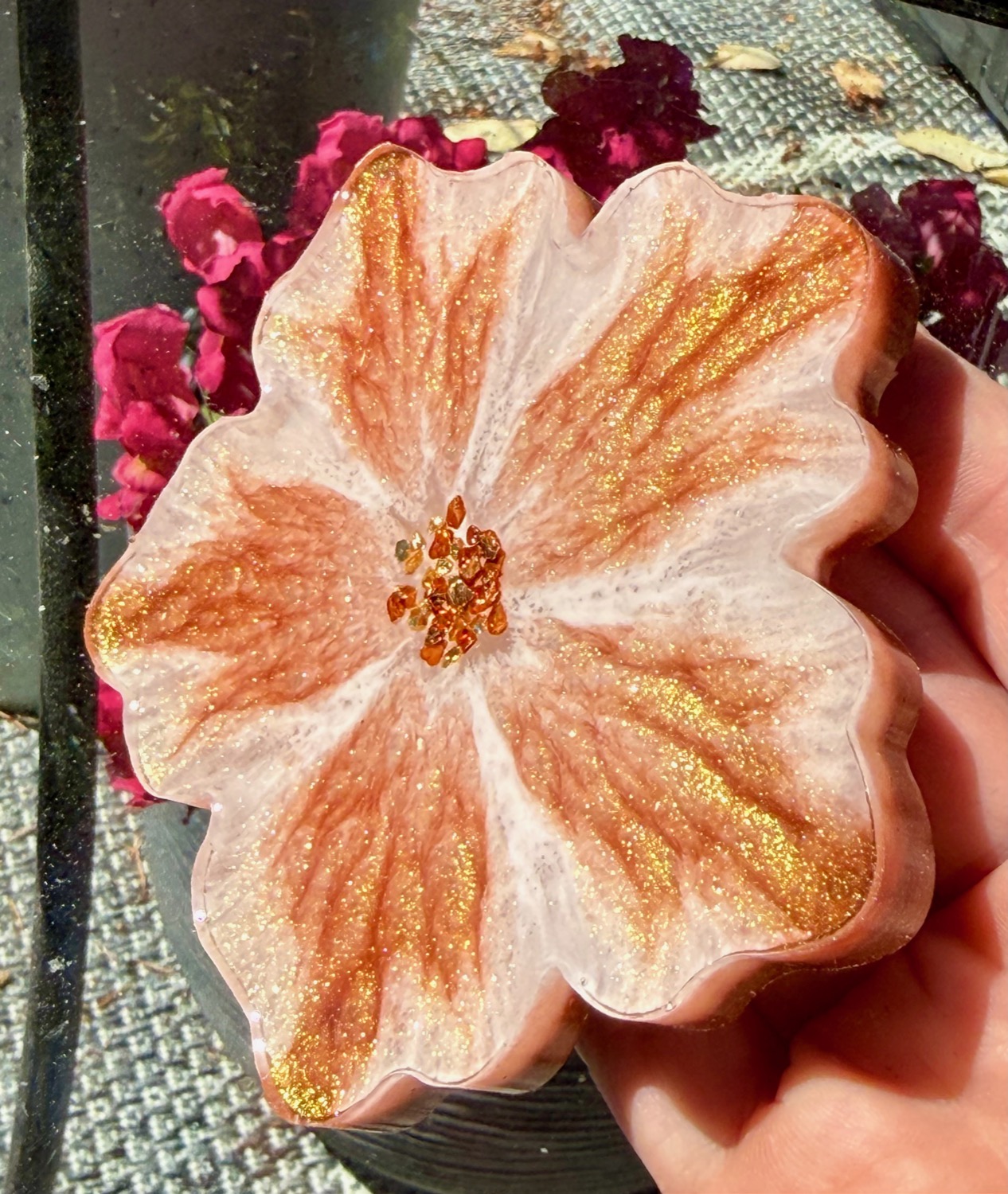 Gilded Petal coaster held in hand