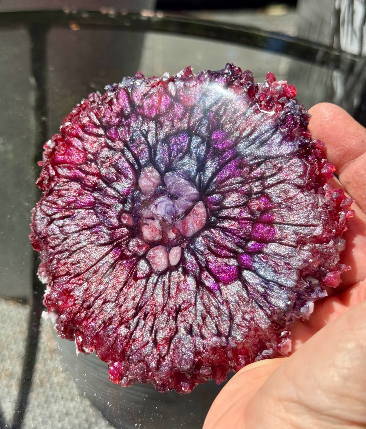 Crimson Geode coaster held in hand