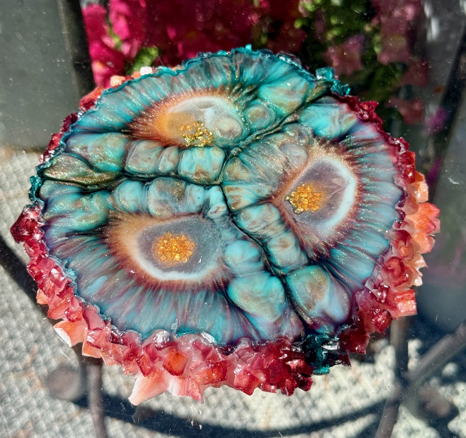 Coral Eye coaster held in hand outdoors